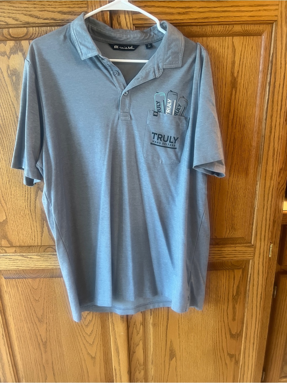 Travis Mathew Men's Light Gray Polo with Truly Seltzer logo